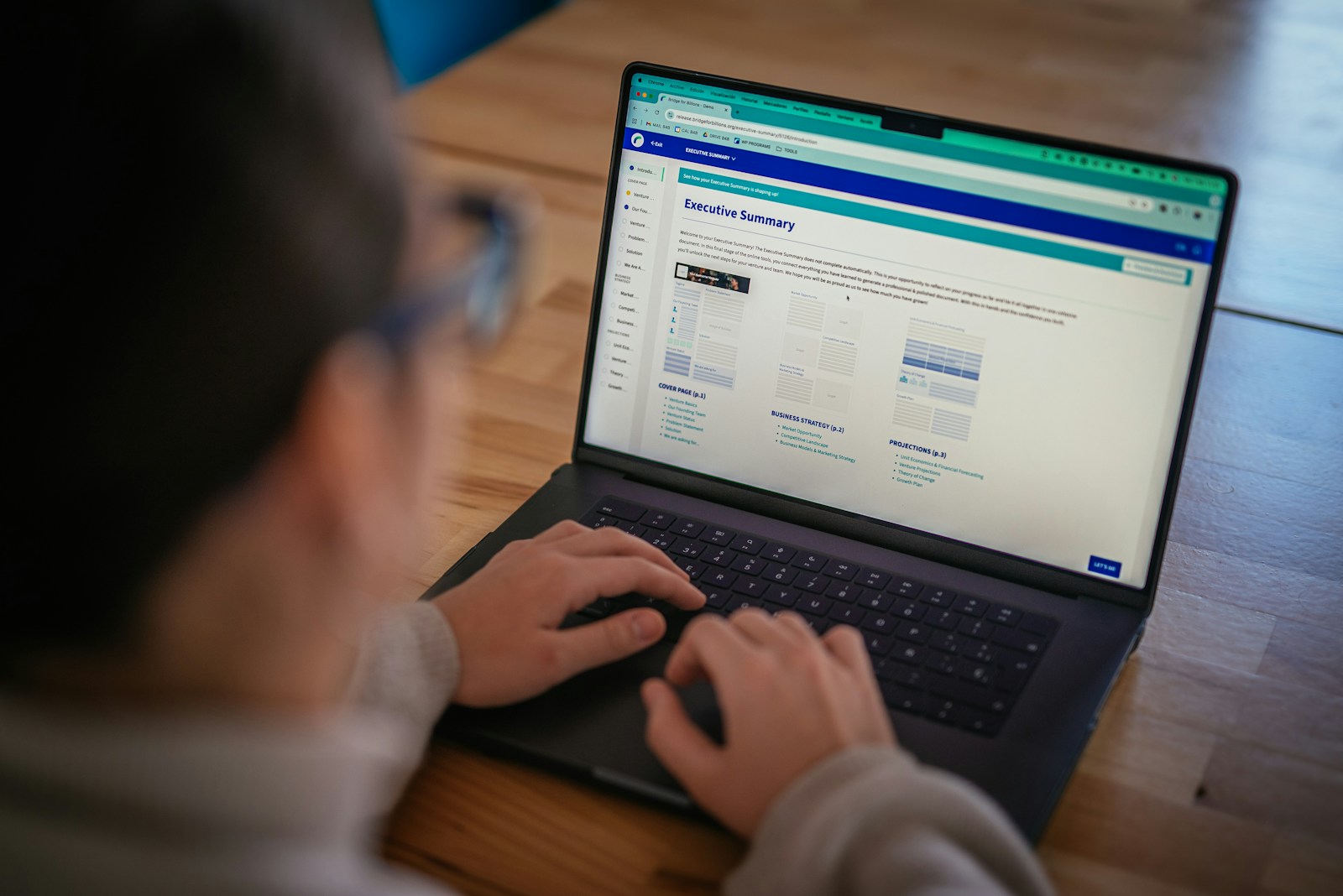 Someone is using a laptop, viewing a webpage.